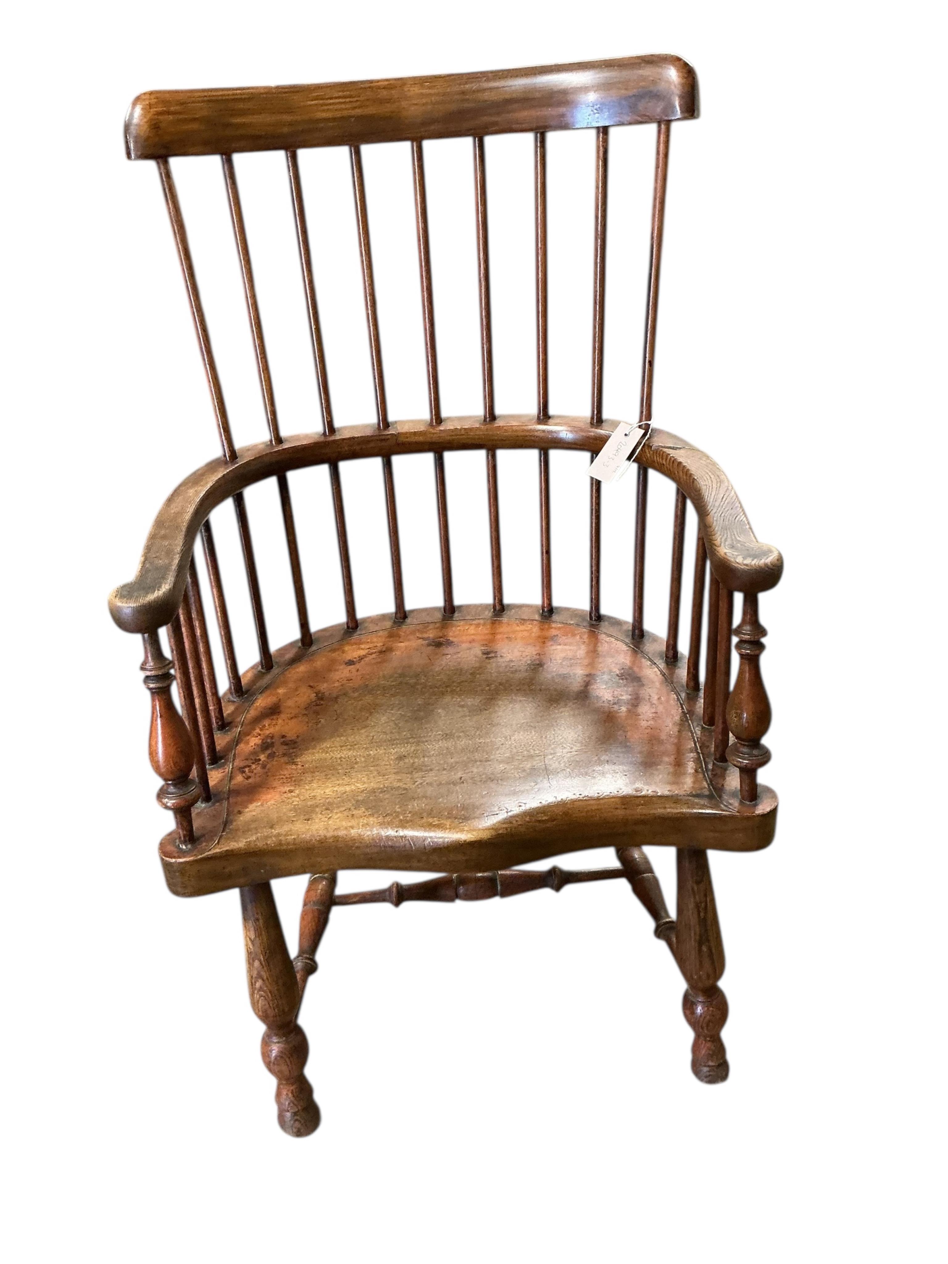 An early 20th century elm and beech Windsor comb back elbow chair, width 57cm, depth 42cm, height 95cm
